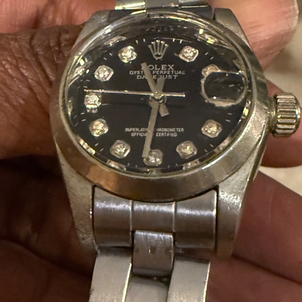 Rolex Silver Timepiece with Dark Dial